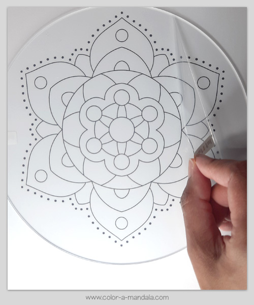 DIY Suncatcher made from a coloring page. Remove the film from the top of the clear plastic disk.