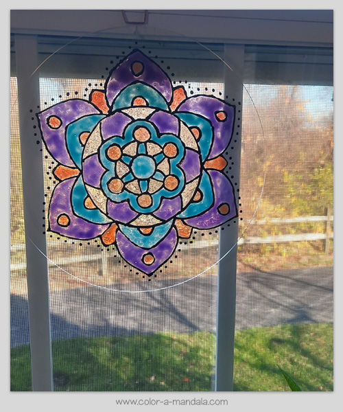 DIY suncatcher made with a coloring page by color-a-mandala